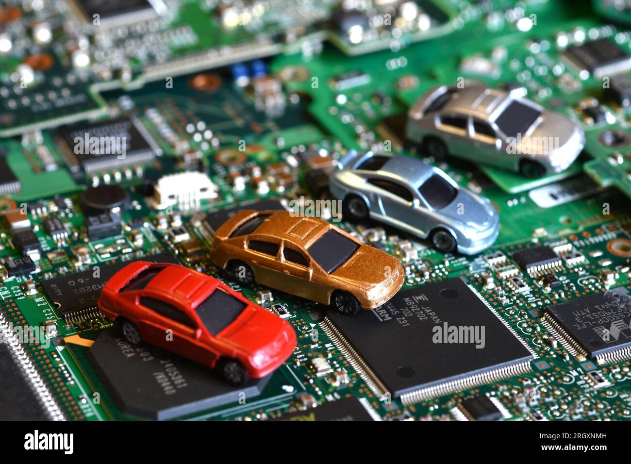 Toy cars on electronic board and microchip. Conceptual image for