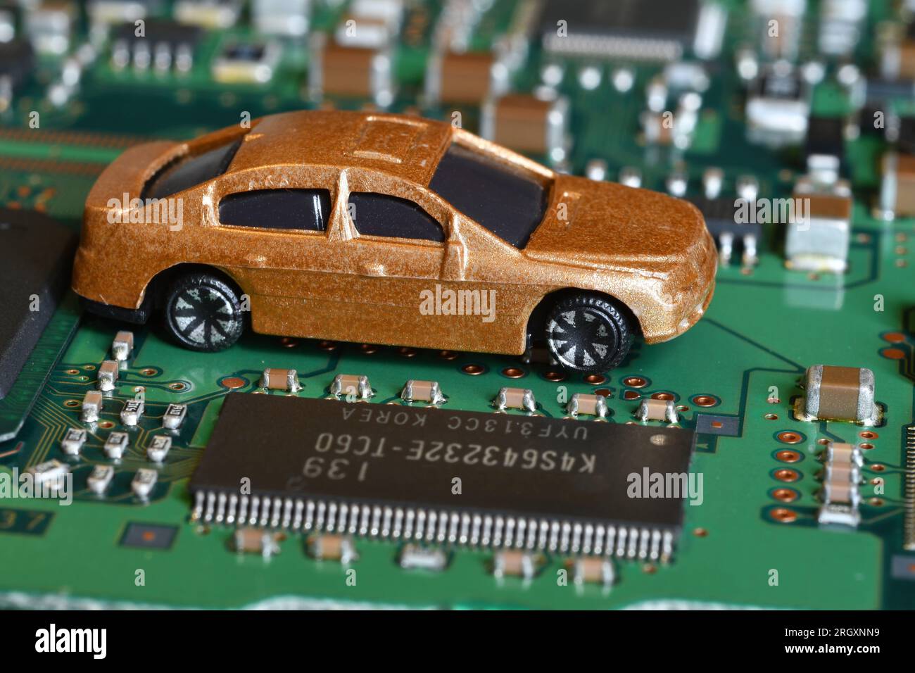 Toy cars on electronic board and microchip. Conceptual image for