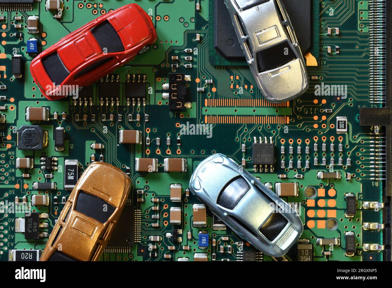 Toy cars on electronic board and microchip. Conceptual image for