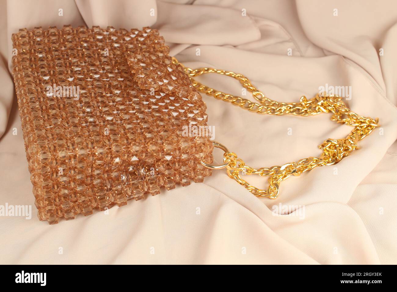 Handmade mink bead bag on cream fabric. Stock Photo