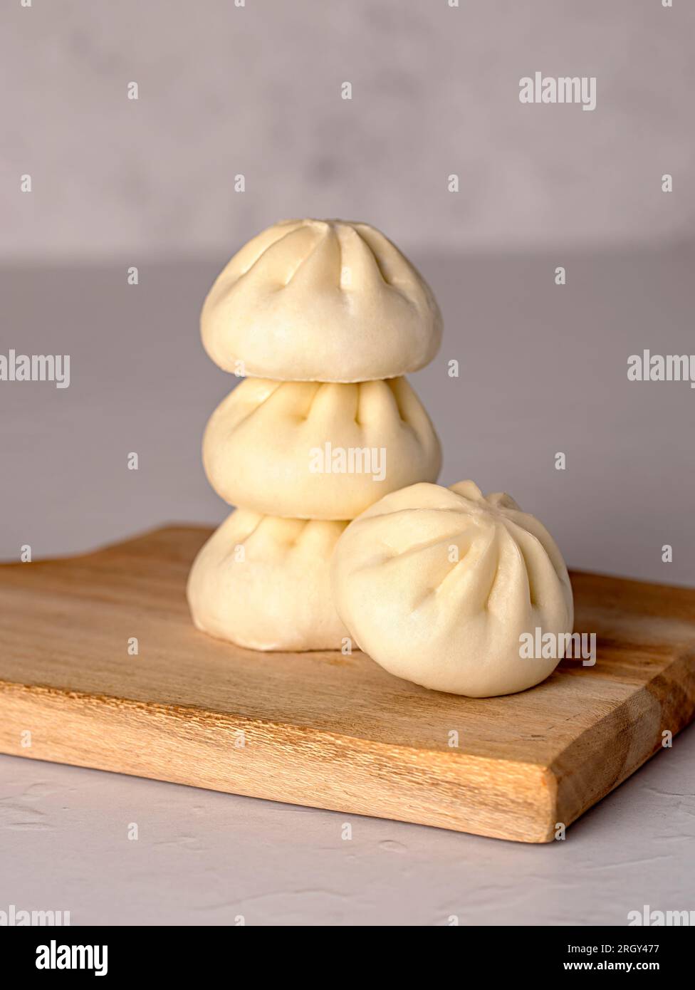 Macro food photography of steamed bun, bao, duck meat, spring onion
