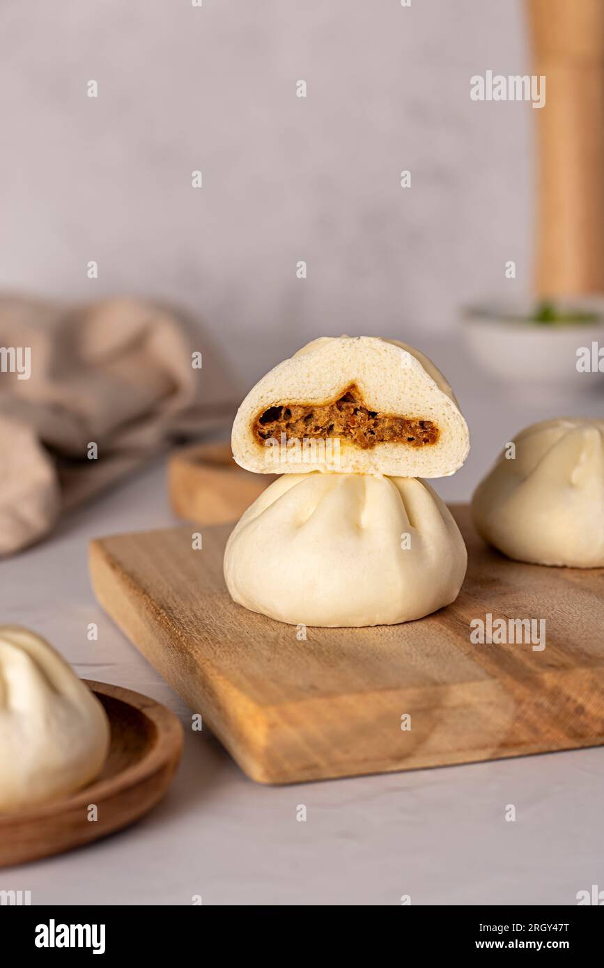 Macro food photography of steamed bun, bao, duck meat, spring onion