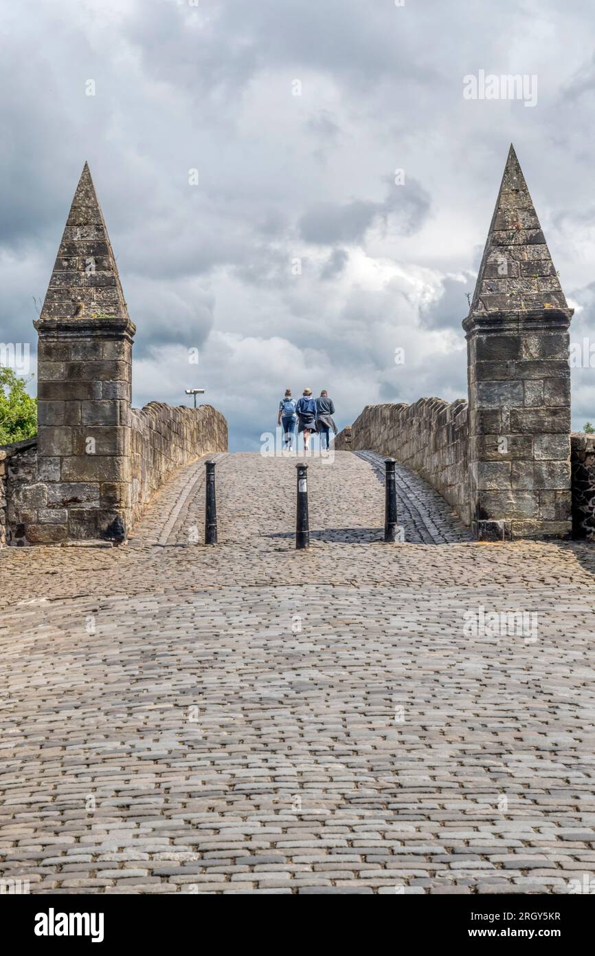 People walking across Old Stirling Bridge over the River Forth. Stock Photo