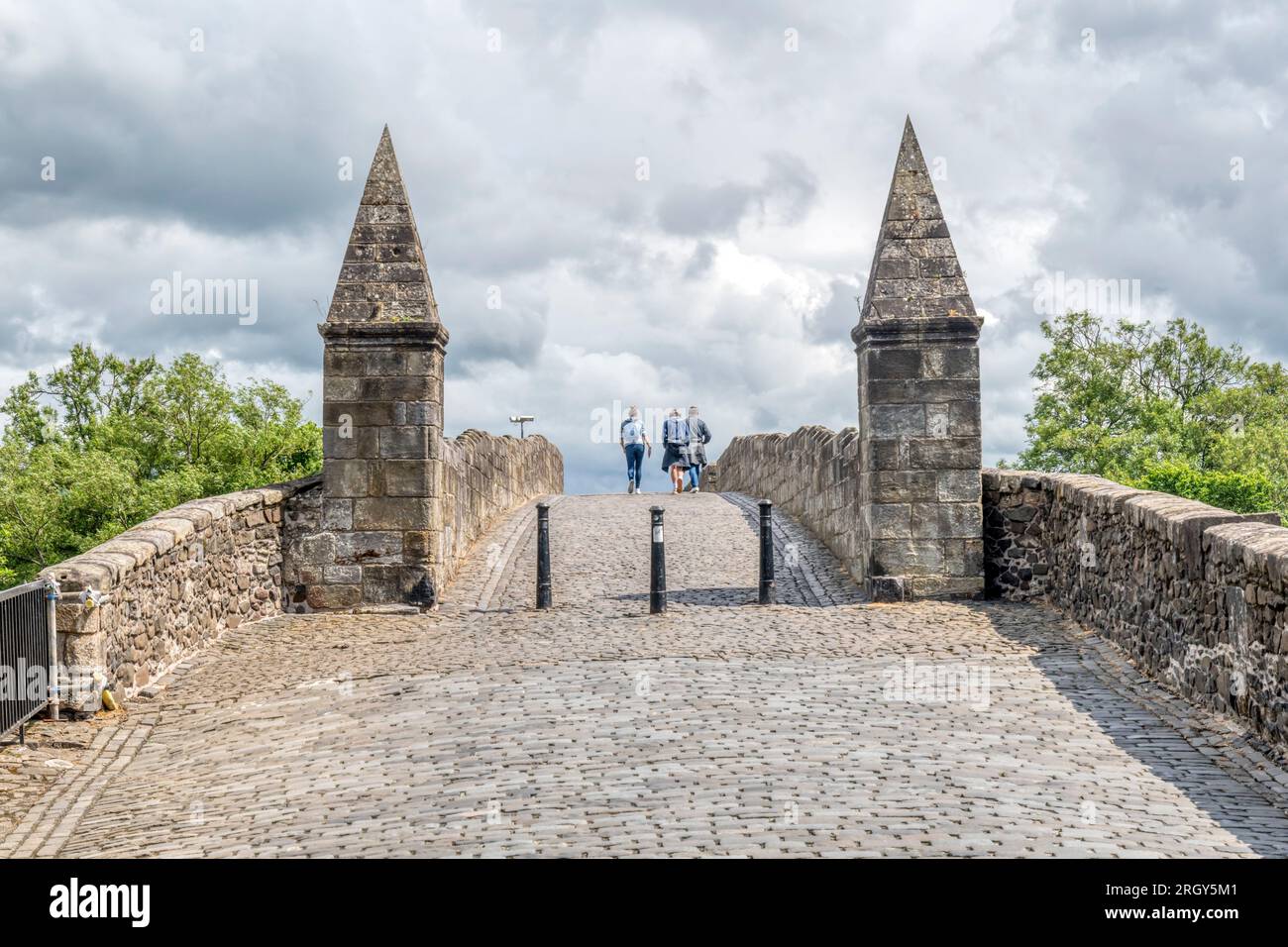 People walking across Old Stirling Bridge over the River Forth. Stock Photo