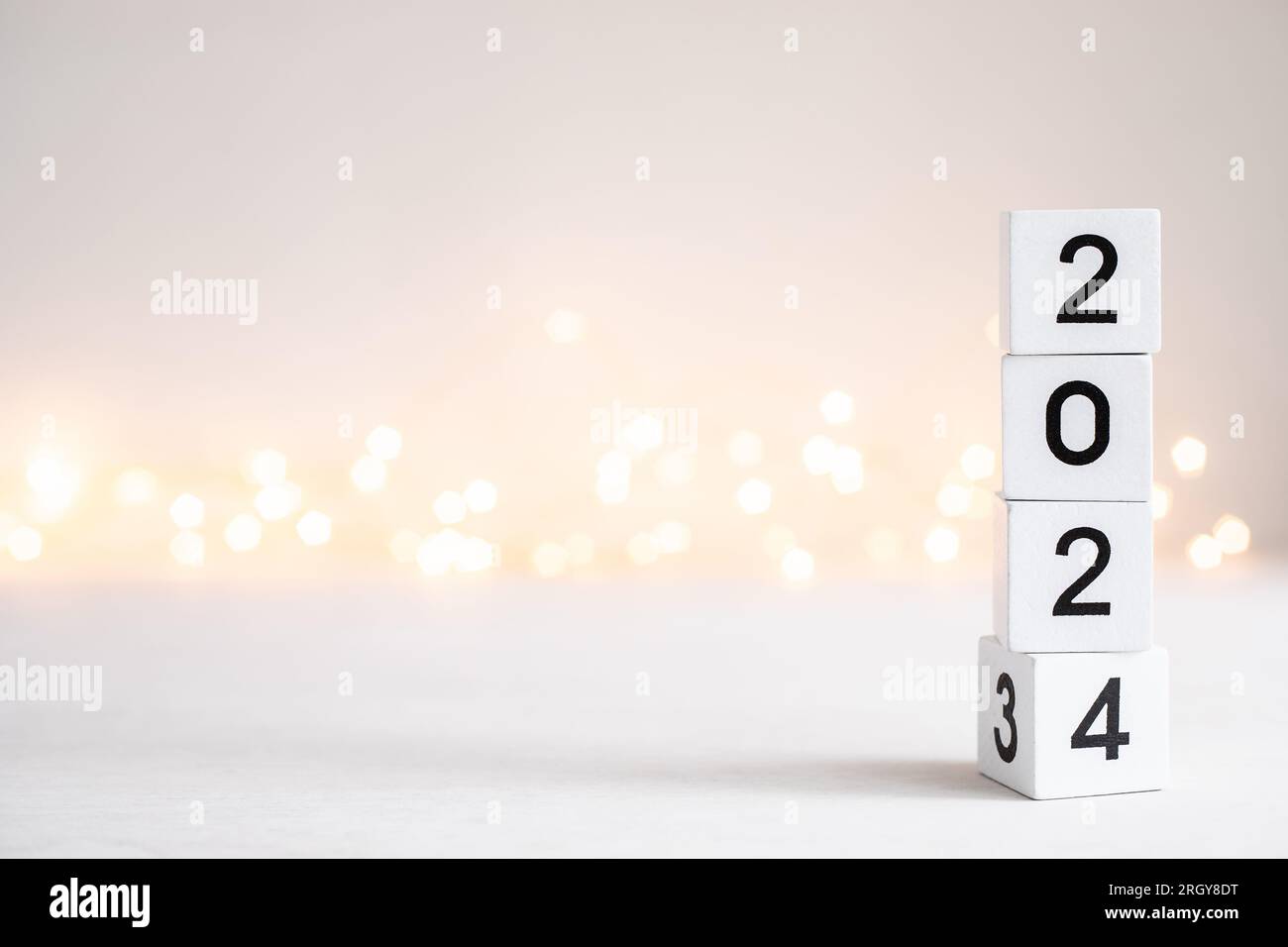 New Year 2025 coming. Numbers on wooden block cubes rotating from 2023