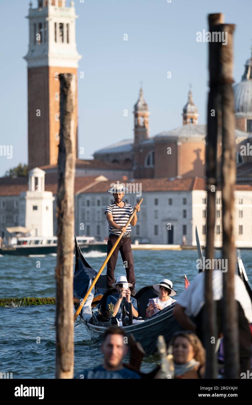 Gondolier travelling the canals of Venice Stock Photo