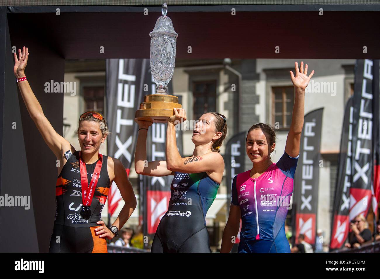 Prachatice, Czech Republic. 12th Aug, 2023. Triathletes L-R third Loanne Duvoisin from Switzerland, first Solenne Billouin from France and second Alizee Paties from France celebrate during the Xterra Czech 2023, race in cross triathlon, part of the Xterra World Cup, European Tour, on August 12, 2023. Credit: Vaclav Pancer/CTK Photo/Alamy Live News Stock Photo