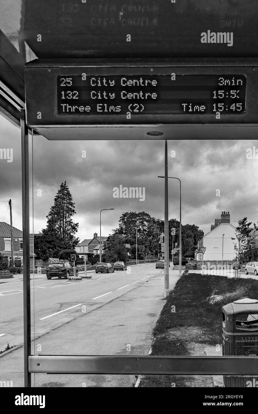 Cardiff, Wales, UK - Bus timetable showing the next buses at a bus stop. Council service cuts, reduced bus service, public service cuts. Welsh Govn. Stock Photo