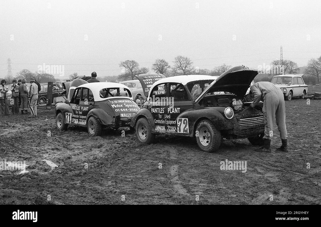Two Morris Minor cars at an autocross event at Smallfield in Surrey, England on March 6, 1977. The car was manufactured in the UK from 1948 to 1971. Stock Photo