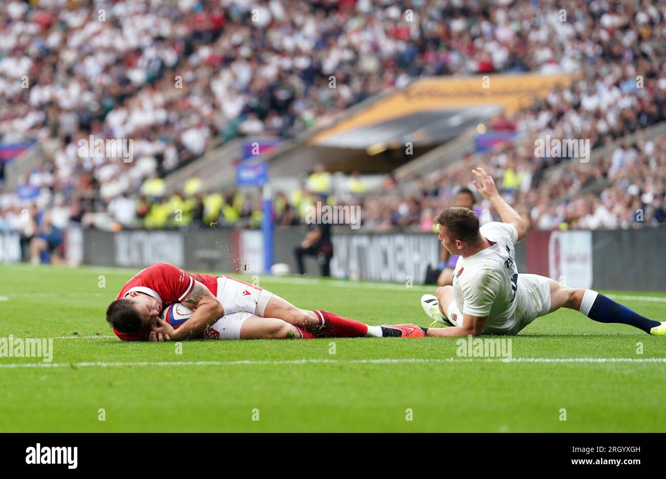 England's Freddie Steward tackles Wales' Josh Adams in the air and a penalty try is awarded to Wales on review during the Summer Nations Series match at Twickenham Stadium, London. Picture date: Saturday August 12, 2023. Stock Photo