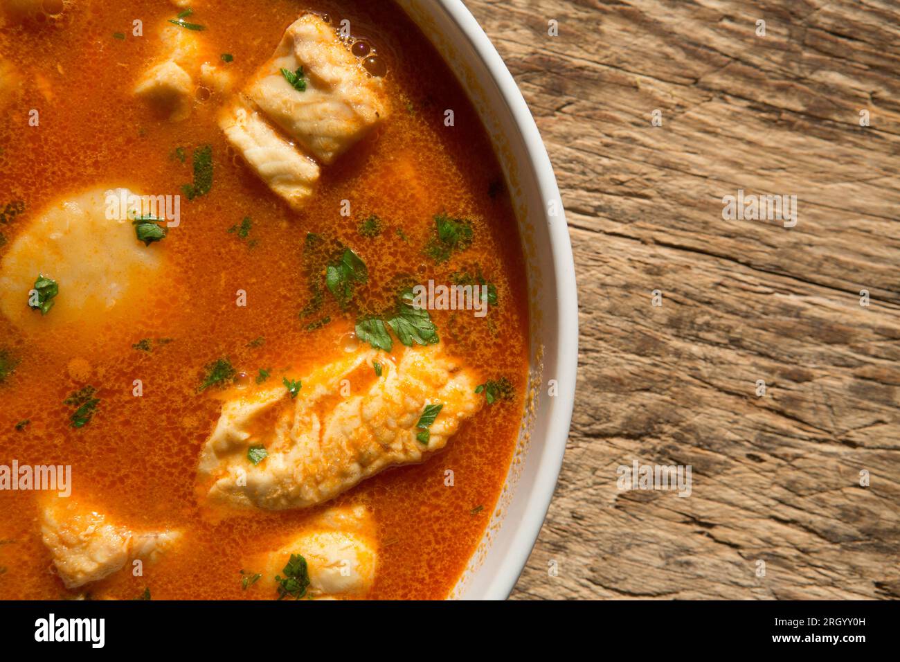 A bowl of fish stew or bouillabaisse, that has been made with king scallops, smooth hound, anglerfish also known as monkfish and gurnard fillets. Engl Stock Photo