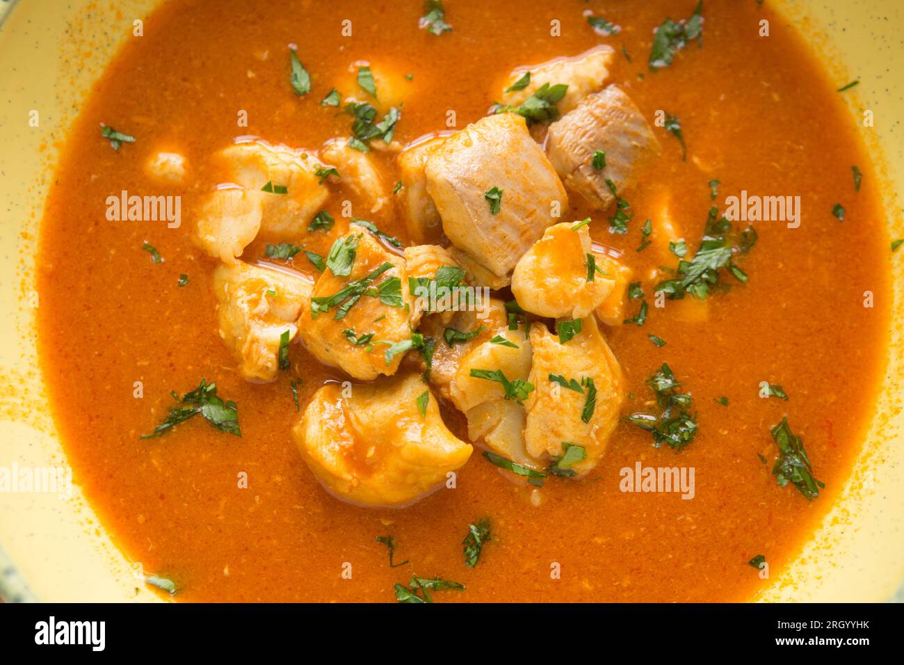 A bowl of fish stew or bouillabaisse, that has been made with king scallops, smooth hound, anglerfish also known as monkfish and gurnard fillets. Engl Stock Photo