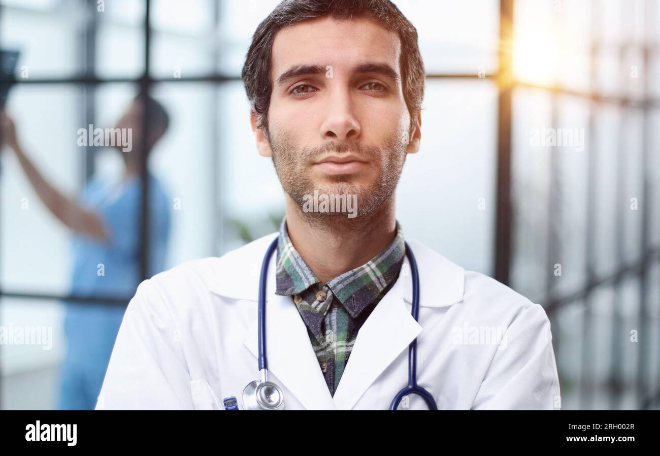 Headshot portrait male doctor or therapist in white medical uniform