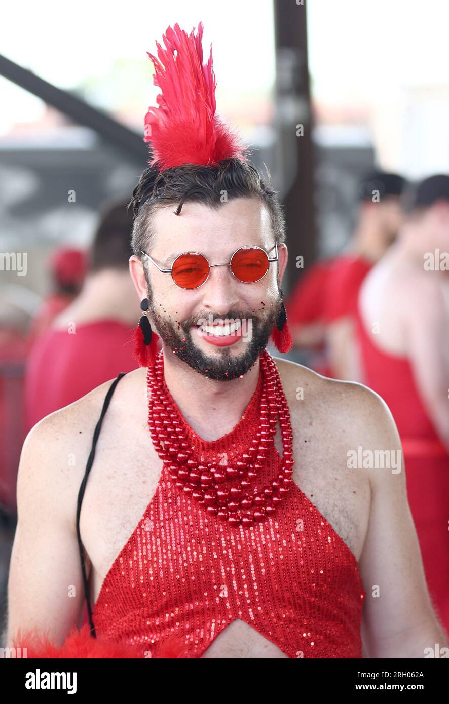 New Orleans, USA. 12th Aug, 2023. Event goers participate in the Red Dress Run activities at the