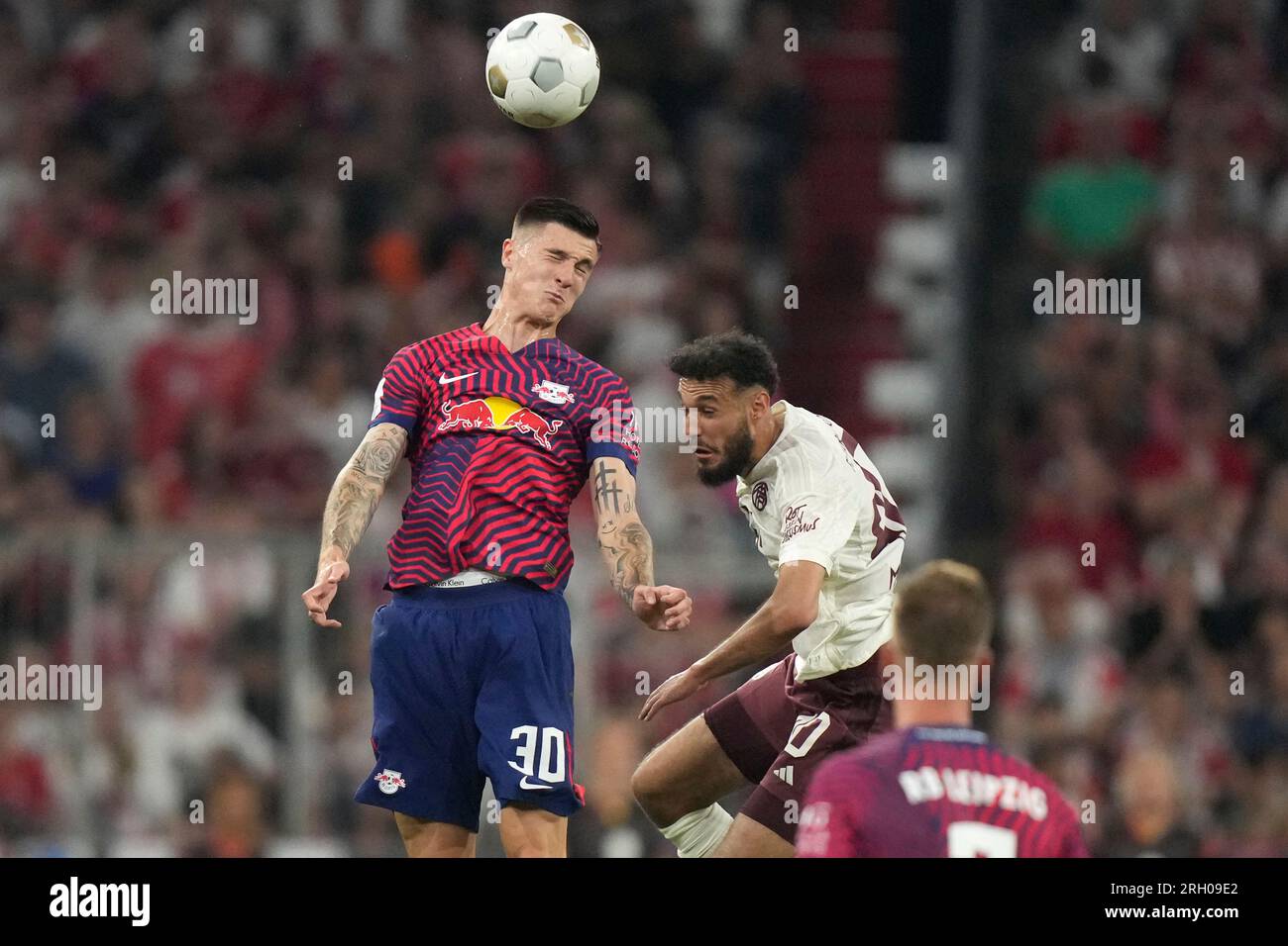 Leipzig's Benjamin Sesko, top, heads the ball during the German