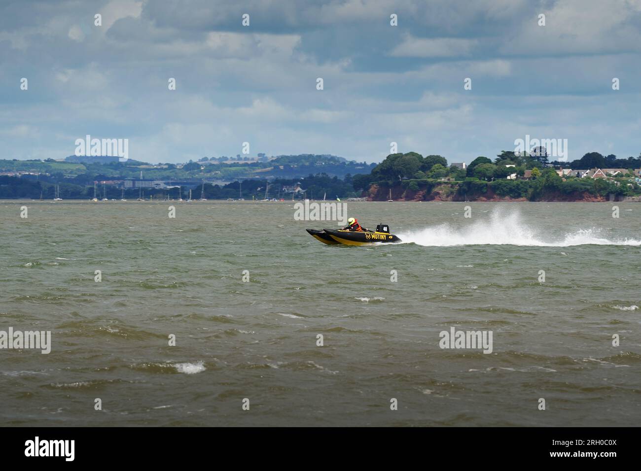 Exmouth, UK - August 2023:A twin hull catamaran racing in the river Exe estuary in Exmouth, UK Stock Photo