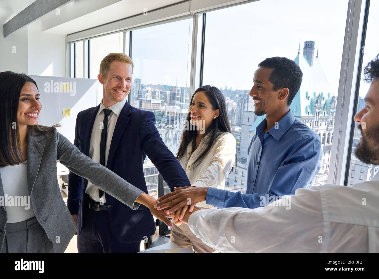 International business team people joining hands together in stack in ...