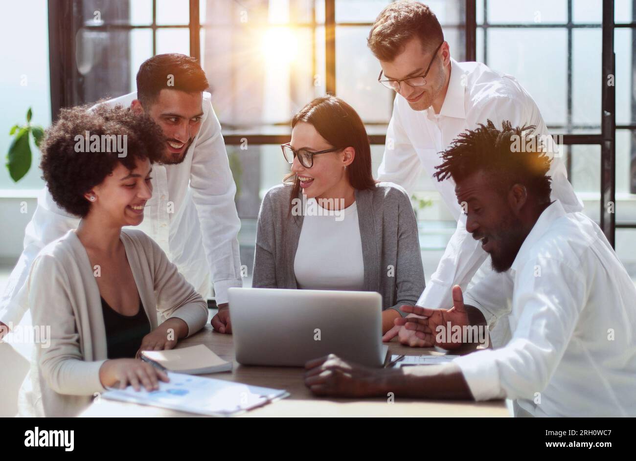 Employees working at computer together, discussing content Stock Photo ...