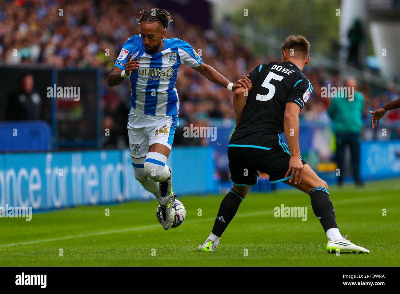 John Smith's Stadium, Huddersfield, England - 12th August 2023 Sorba Thomas (14) of Huddersfield Town is tackled by Callum Doyle (5) of Leicester City - during the game Huddersfield Town v Leicester City, Sky Bet Championship,  2023/24, John Smith's Stadium, Huddersfield, England - 12th August 2023 Credit: Mathew Marsden/WhiteRosePhotos/Alamy Live News Stock Photo