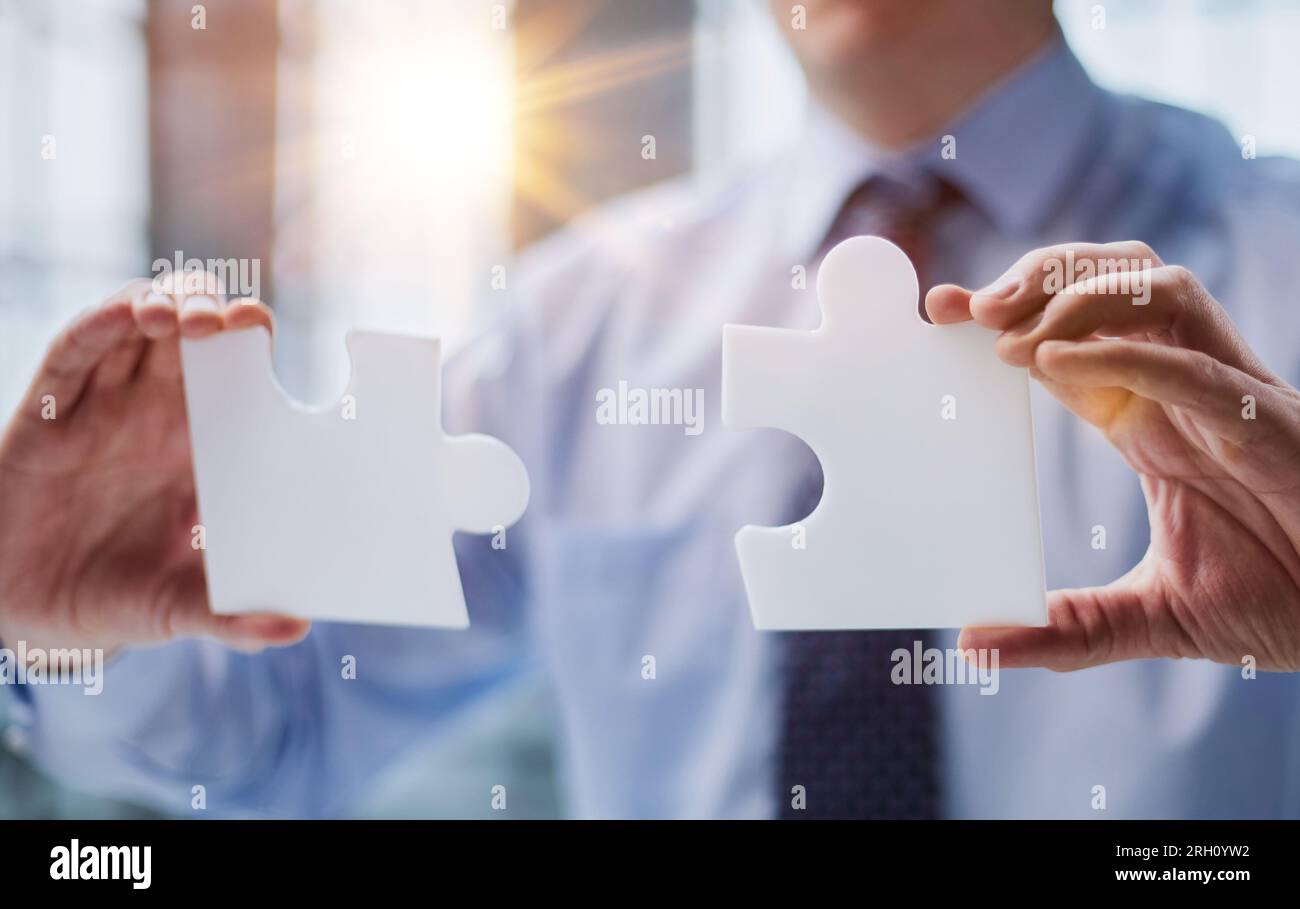 optimistic businessman holding a puzzle piece, solving problems Stock ...