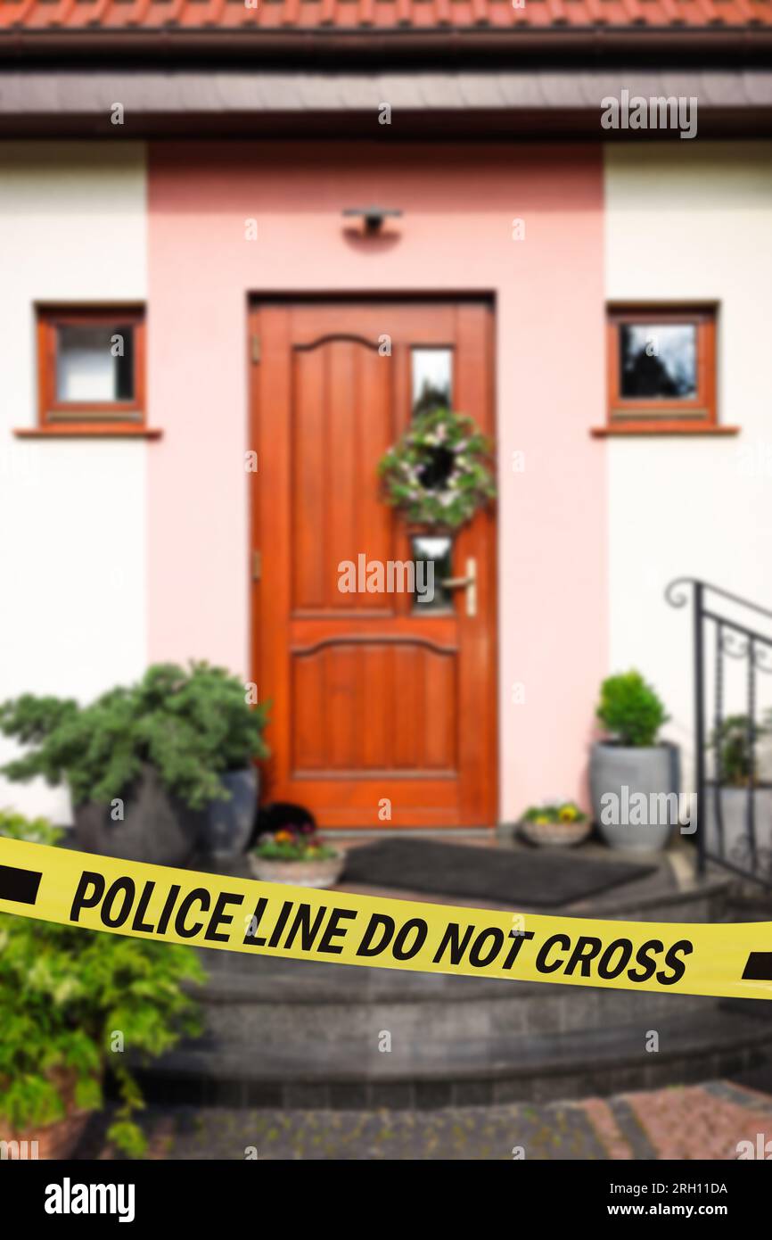 Yellow crime scene tape blocking way to house outdoors Stock Photo Alamy