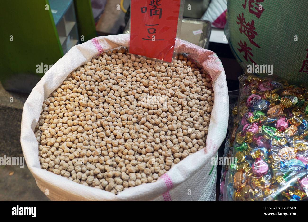 heap of raw fresh chickpeas (Cicer arietinum) in bulk Bags, in the corner of the traditional retail store. Stock Photo