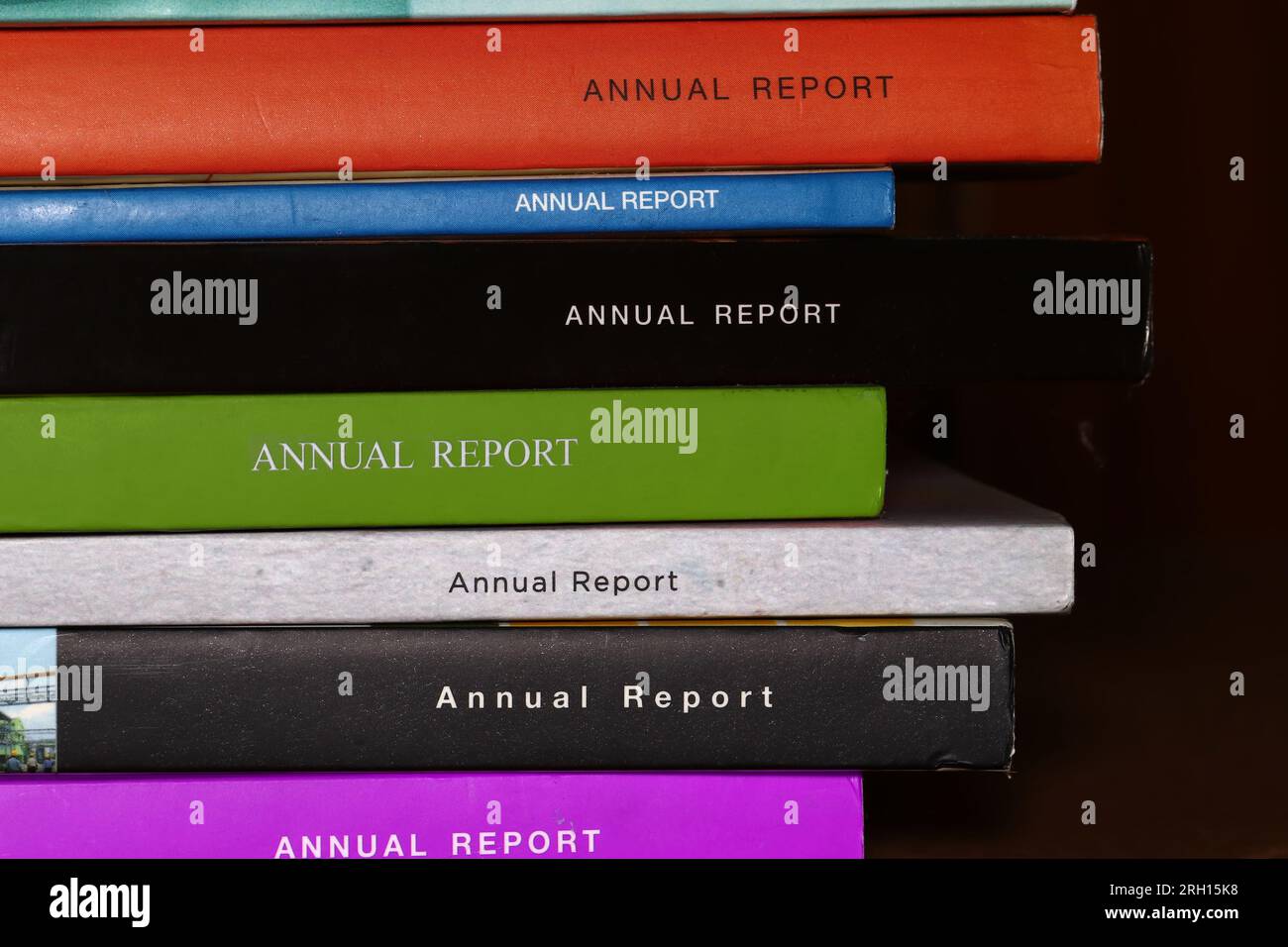 Close-up on the spines of a collection of printed hard copy corporate annual reports Stock Photo