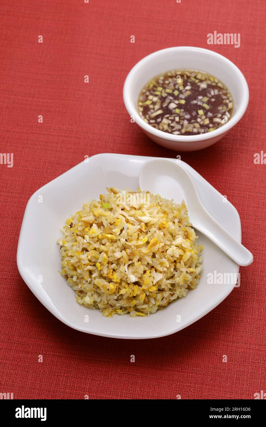 crab meat fried rice, Chinese cuisine isolated on red background Stock Photo