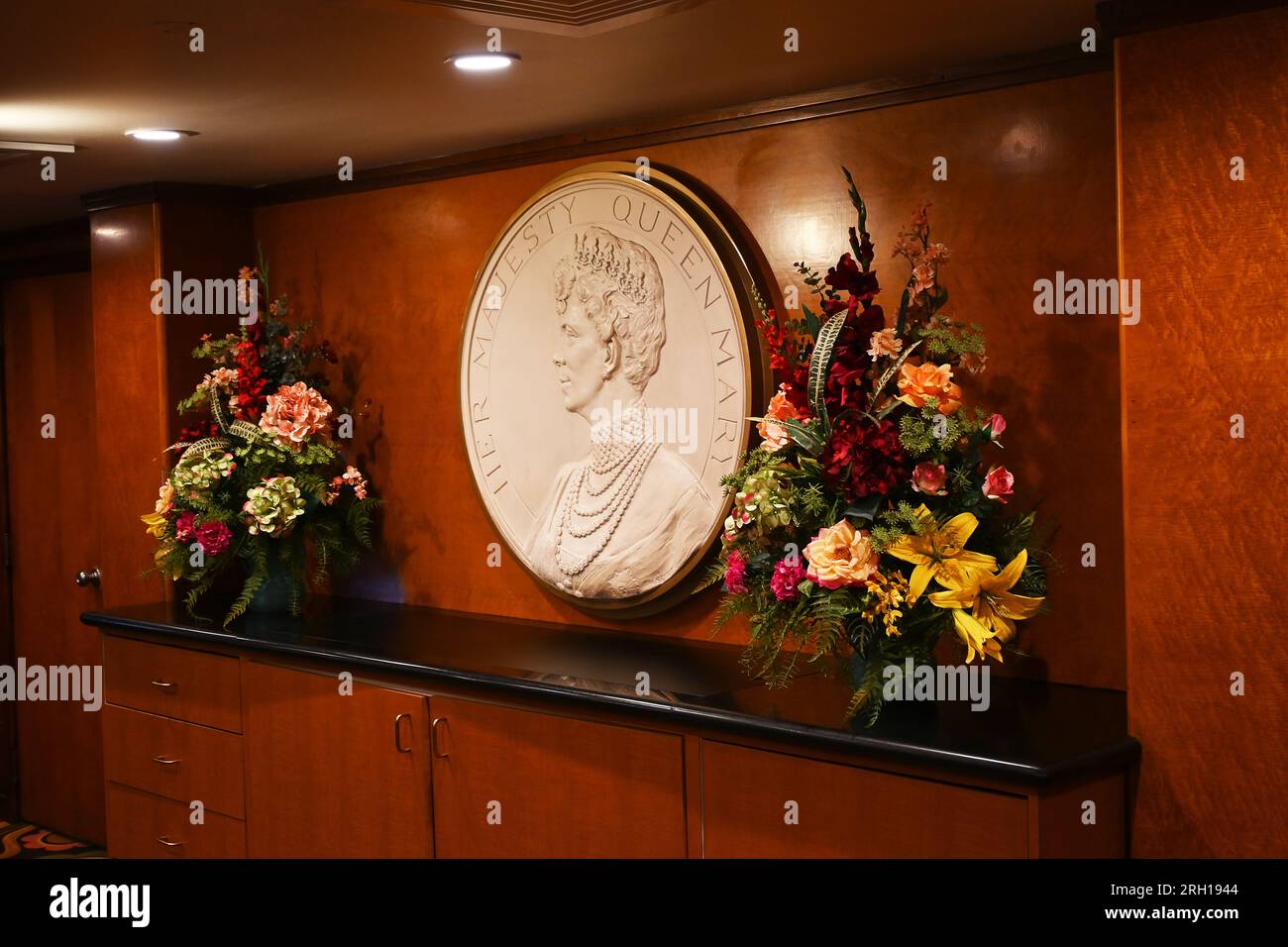 LONG BEACH, CALIFORNIA - 14 JUN 2023: Plaque with a portrait of Queen Mary behind the reception desk of the ocean liner converted into a hotel Stock Photo
