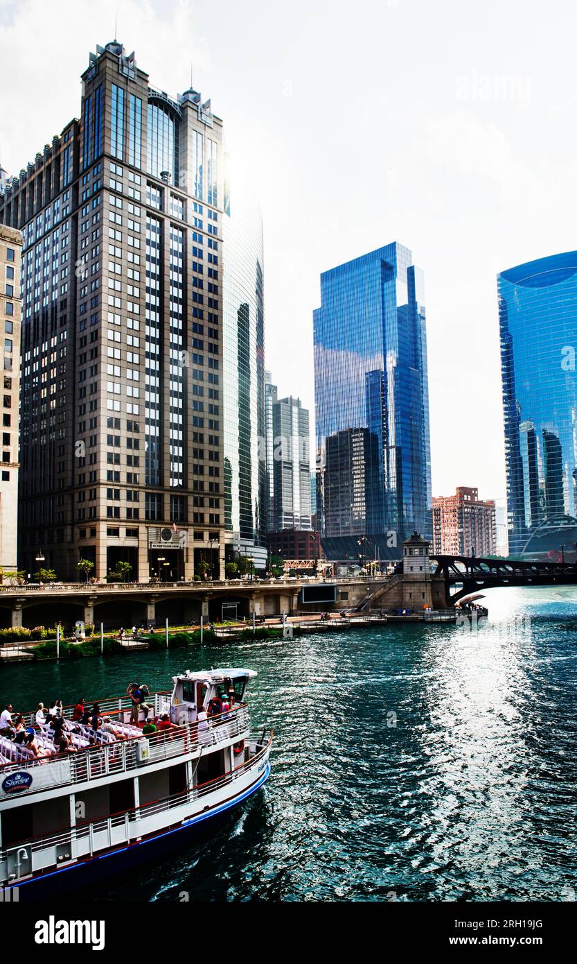 Chicago Cityscape from Chicago River Waterfront at Dusk. Small boats and tourist ferries