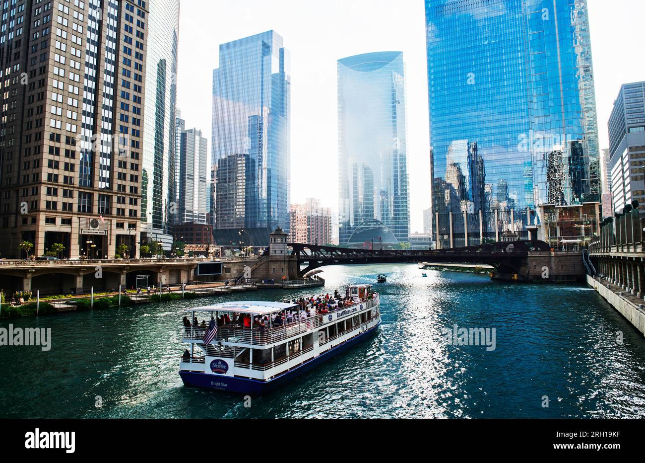 Chicago Cityscape from Chicago River Waterfront at Dusk. Small boats and tourist ferries