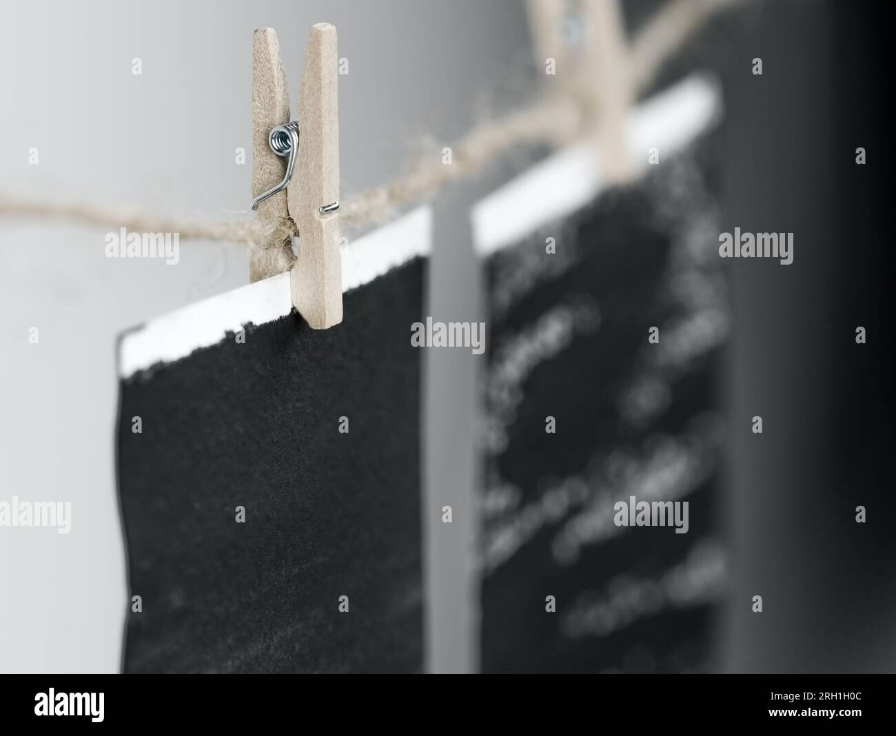 Close-up of photo frames hanging on the rope with wooden pins. Stock Photo