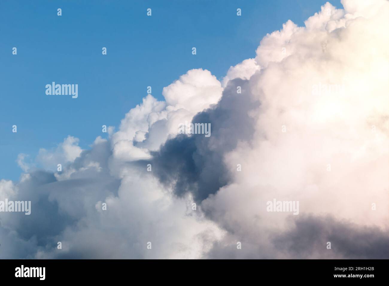 Dark stormy clouds on blue sky background. Stock Photo