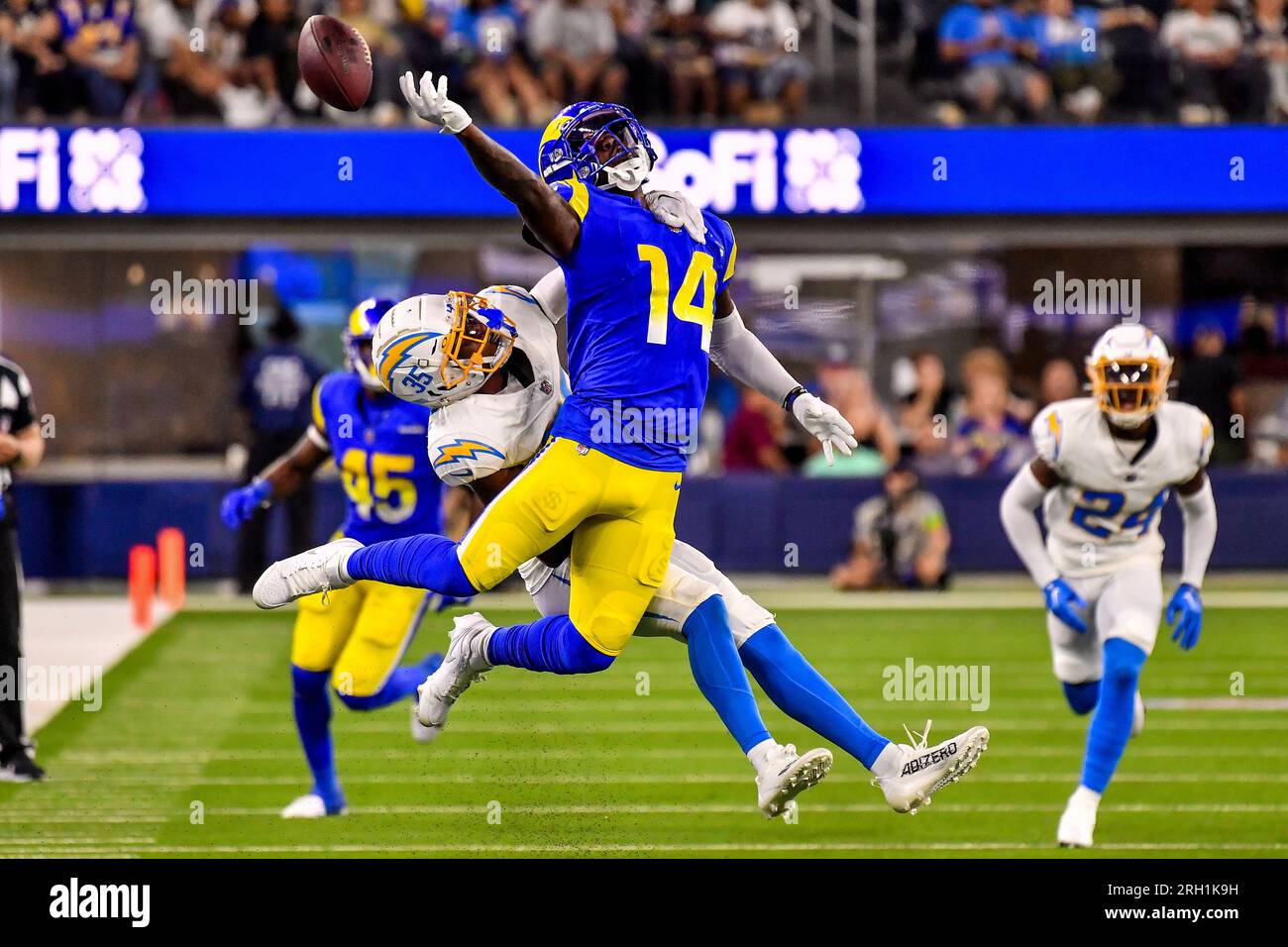 Los Angeles Rams wide receiver Tyler Johnson (14) reaches for the pass  while being held by Los Angeles Chargers cornerback AJ Uzodinma (35) in a  NFL preseason game. The Chargers defeated the