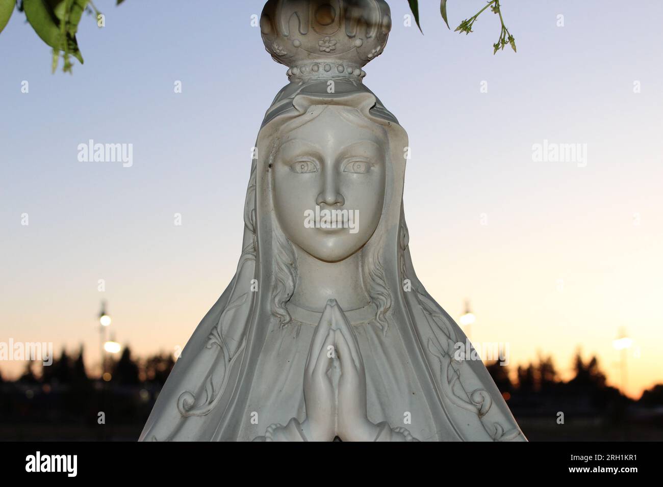'Divine Serenity-A captivating marble statue of a woman in prayer, evoking a profound sense of peace and spiritual contemplation.' Stock Photo