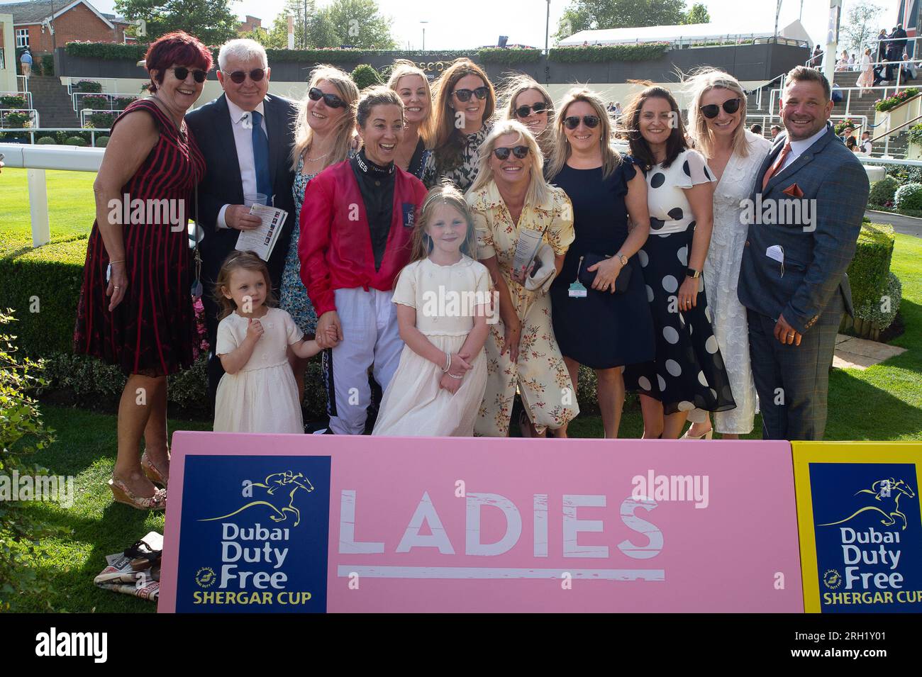 Ascot, Berkshire, UK. 12th August, 2023. The Ladies Team Captain, Hayley Turner has a photo with her family and friends at Ascot Racecourse after her team won the Dubai Duty Free Shergar Cup. Credit: Maureen McLean/Alamy Live News Stock Photo