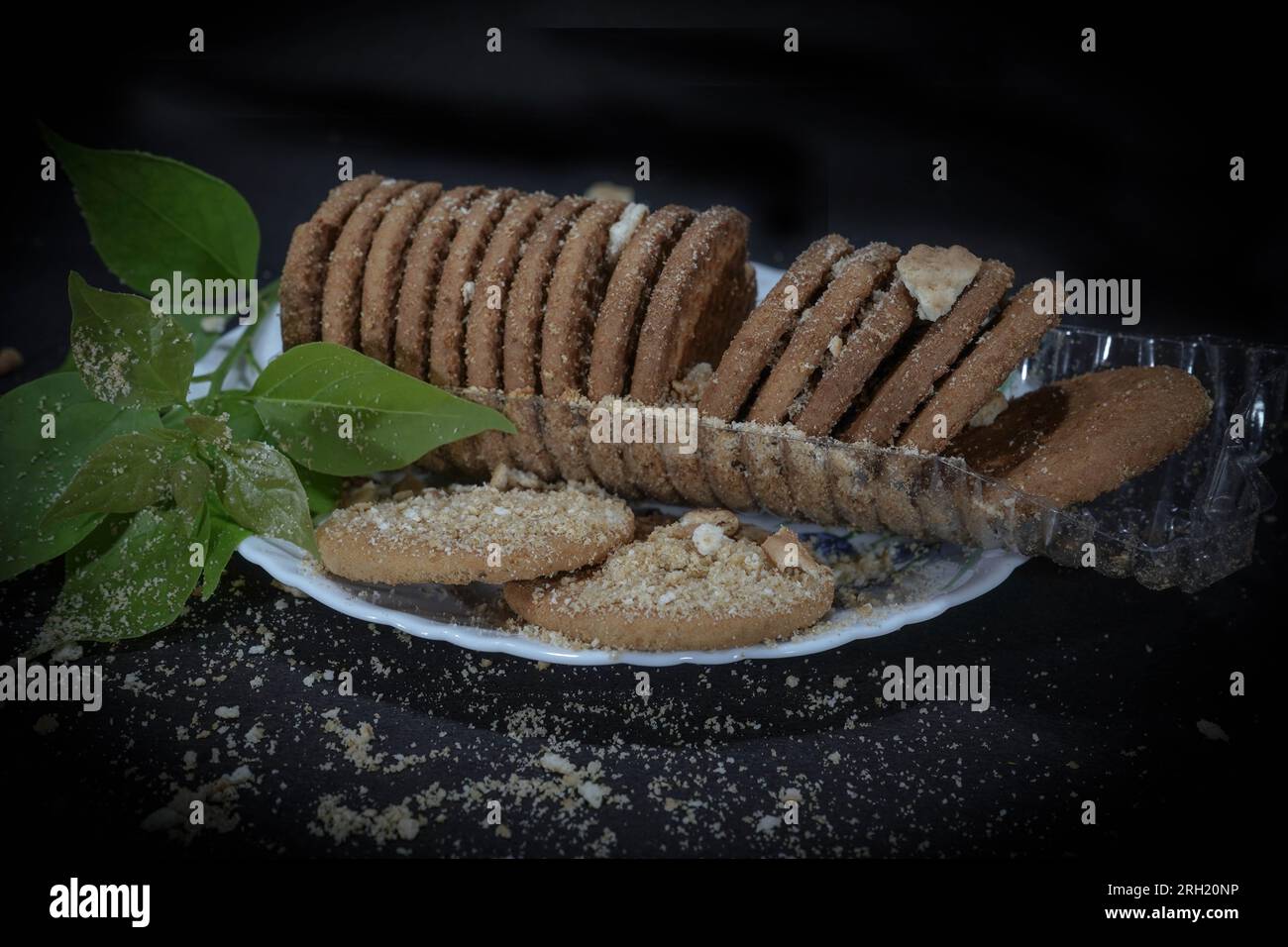 Wheat biscuits in the white melamine plate with black background. Indian biscuits popularly
