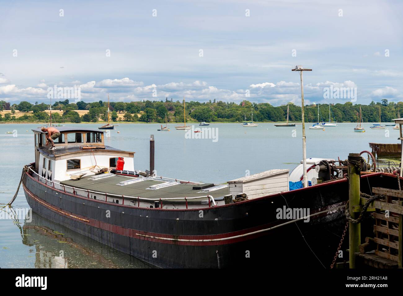 Houseboat moored in the picturesque riverside village of Pin Mill on