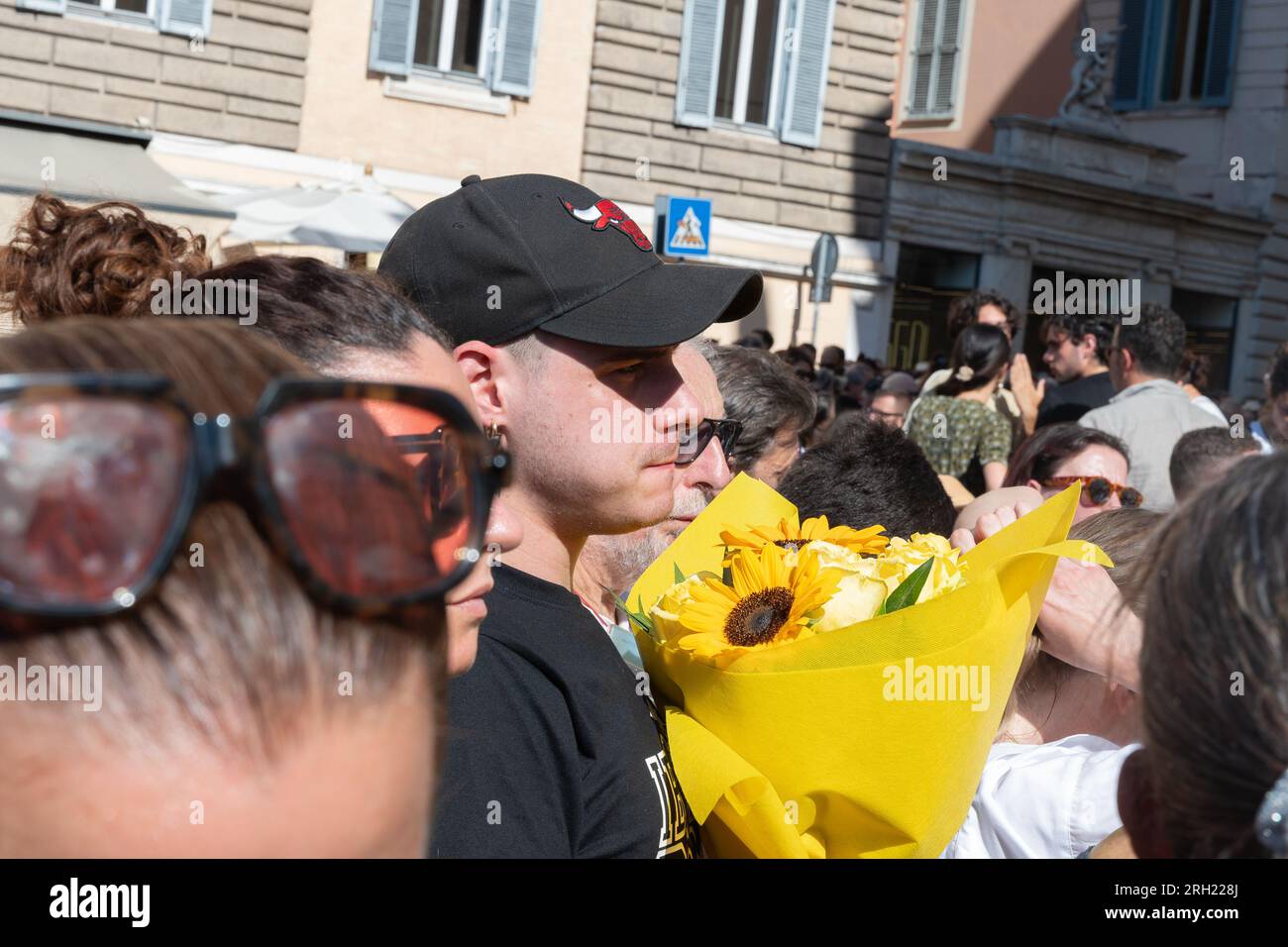 Rome, Italy, Italy. 12th Aug, 2023. The funeral of the writer Michela Murgia took place on 12/8/2023 at the Church of Santa Maria in Montesanto also known as of the Cuhurch of Artists at Piazza del Popolo in Rome, welcomed by a huge crowd of various political and social realities that the church was unable to contain. Present political exponents, such as the secretary of the Democratic Party Elly Schlein, exponents of the ANPI with their flags who sang ''Bella Ciao'' as they exited the coffin, the writer Roberto Saviano and directors such as Paolo VirzÃ¬, interviewed at the conclusion of the Stock Photo