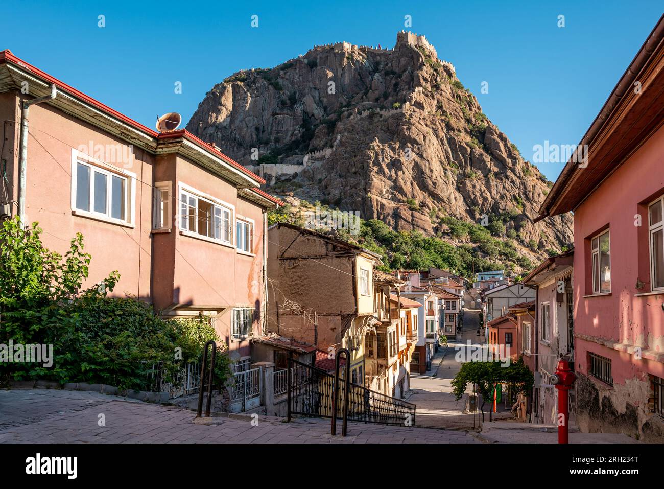 Traditional Afyonkarahisar houses and Afyon Castle in Afyonkarahisar Turkey Stock Photo