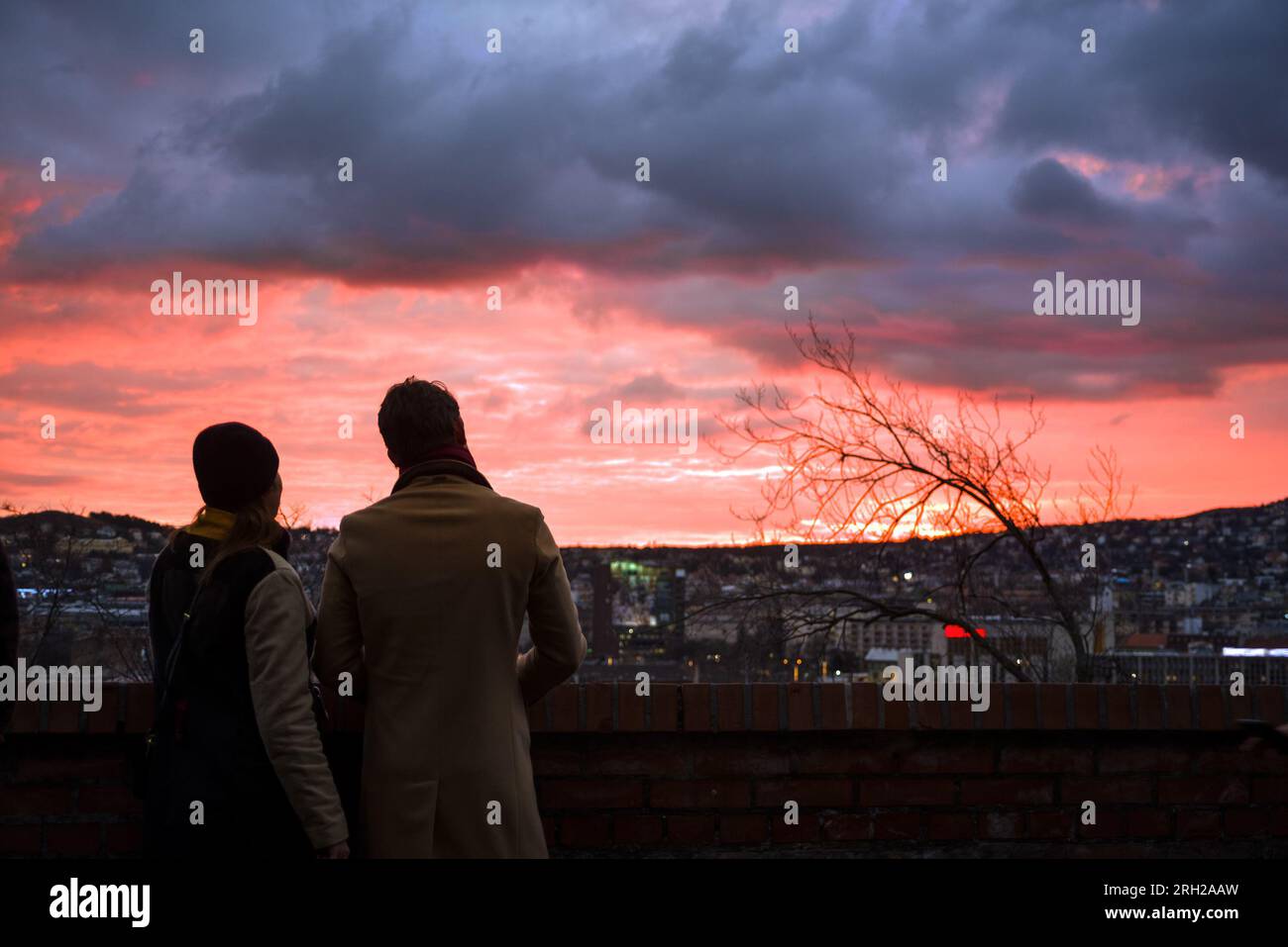 Silhouette of a couple against stormy sunset Stock Photo
