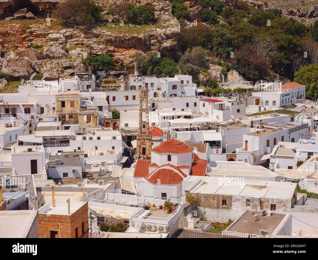 Lindos town in Greece aerial view in cloud summer day, white houses in Rhodes island , cityscape viewpoint traditional greek architecture, famous land Stock Photo