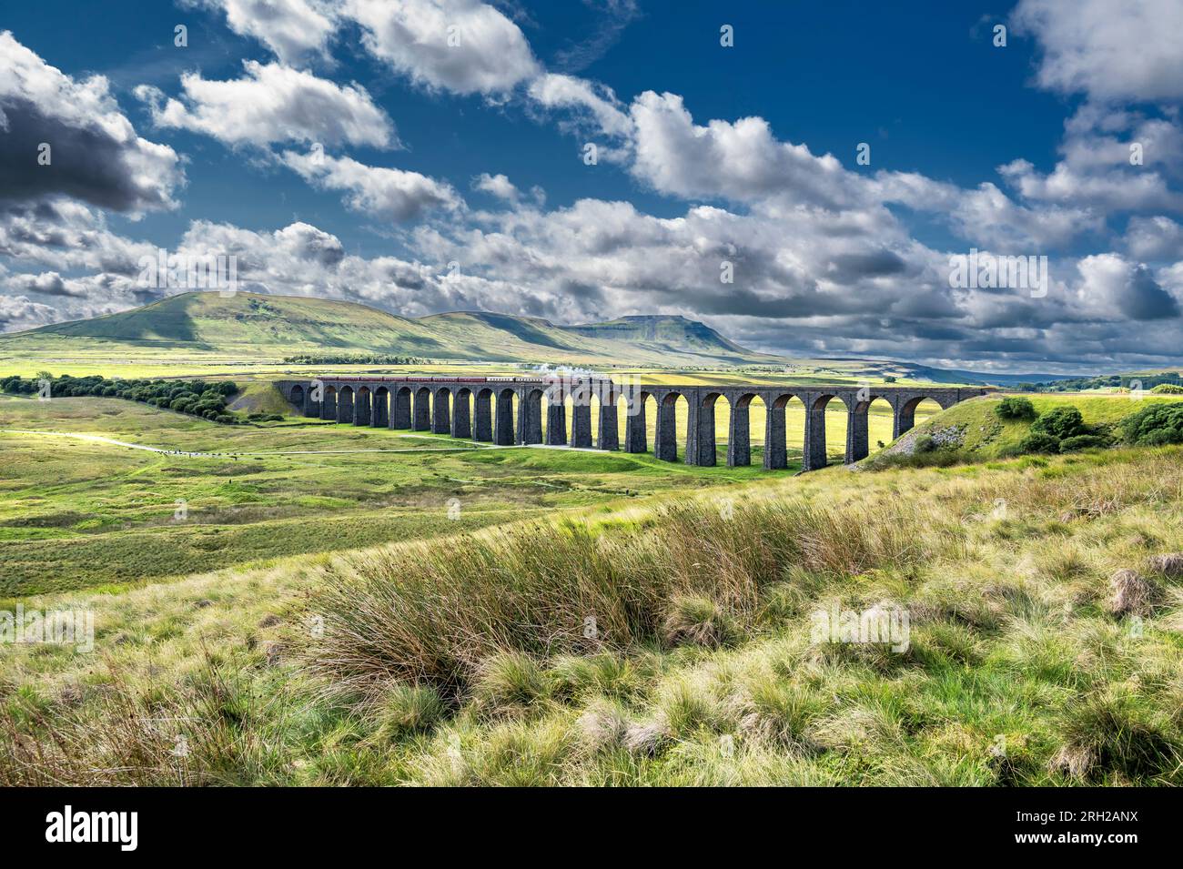 The image is of the British Railways, Black 5 MT, 4-6-0, 44932 steam train passing over the iconic Ribblehead viaduct in the North Yorkshire Dales Stock Photo