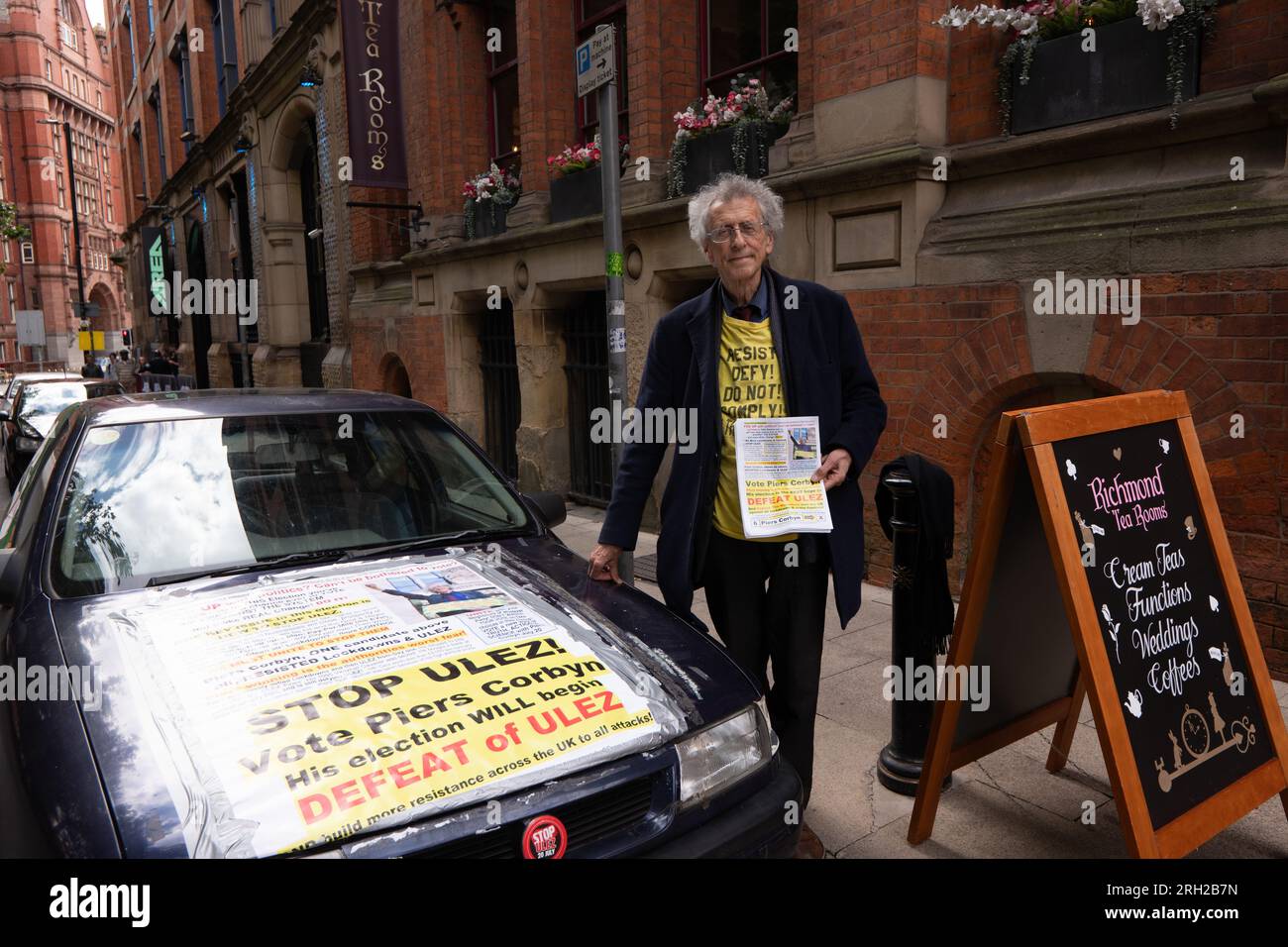 Manchester, UK. 12th Aug, 2023. Piers Corbyn joined a crowd of approximately 80 people turned  on 12th of August 2023 to mark the Peterloo massacre of 16th of August 1819 which took place in Manchester. Organisers blamed a rival 'Peterloo March for democracy' event which is organised for the 19th of August 2023, plus other protests and events including the Manchester Caribbean carnival, a Trans right protest and a Iranian proregime change protest in St Peters square Manchester. The small crowd marched to the Peterloo Massacre memorial in central Manchester. In attendance was climate change den Stock Photo