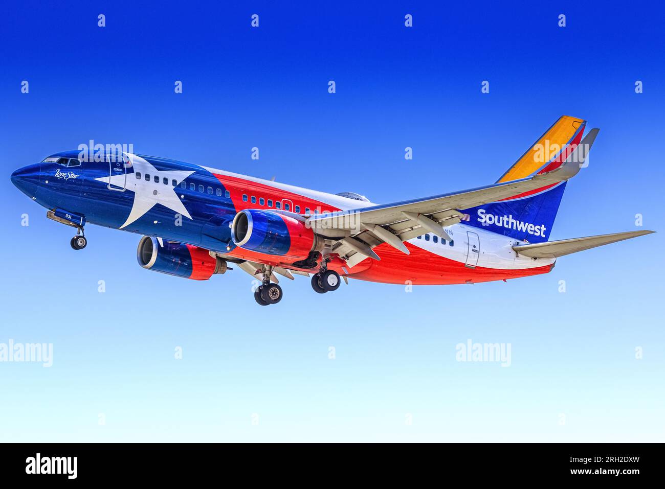 Southwest Airlines' aircraft Boeing 737-7H4 N931WN features the distinctive Lone Star livery, paying homage to Texas' heritage. The design reflects Southwest's strong connection to the state and its role as a prominent player in the aviation industry. Seen during a landing at Palm Springs Airport in March 2023 Stock Photo