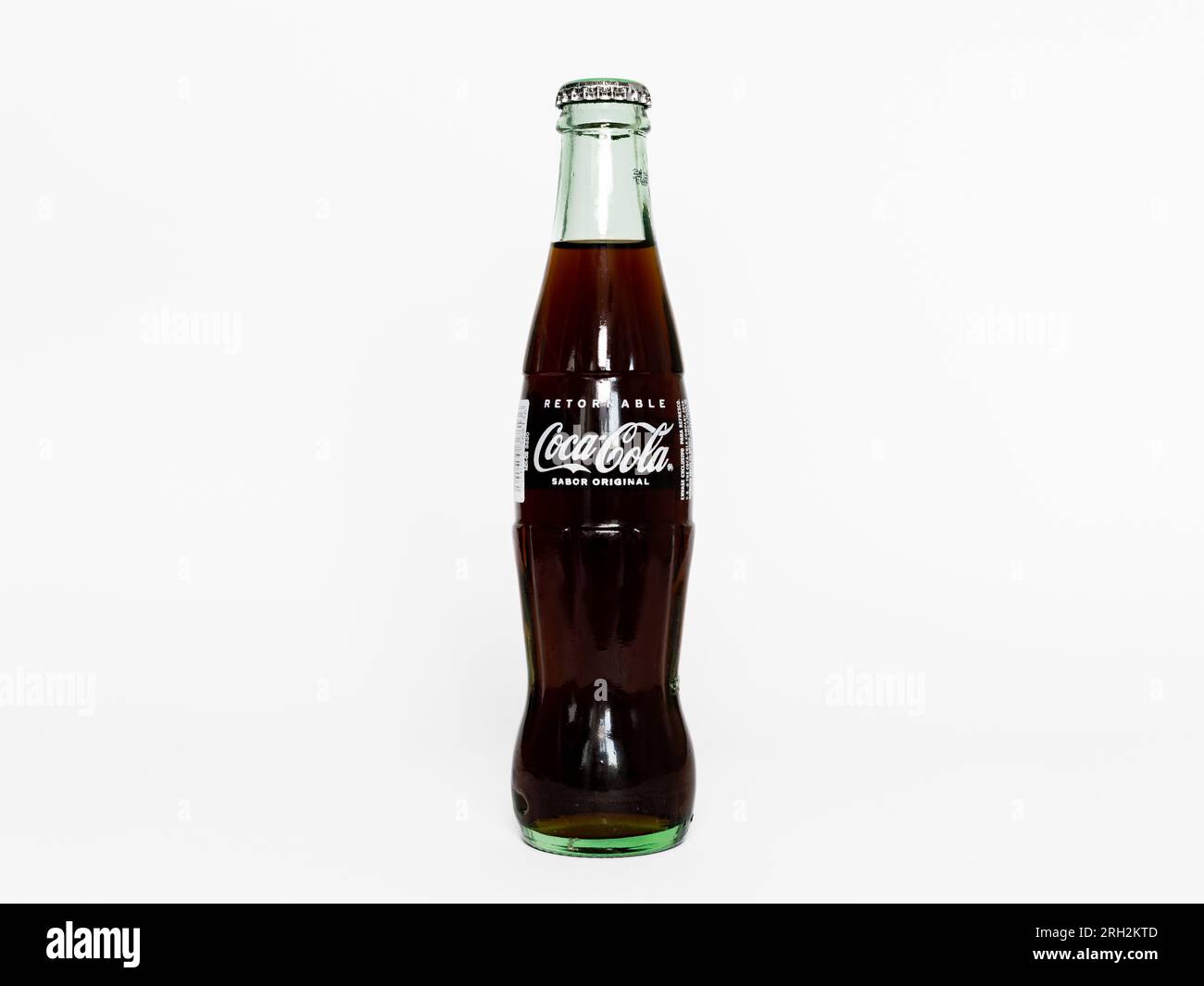 Mexican Coca Cola with the sabor original flavor. The coke drink is in a transparent glass