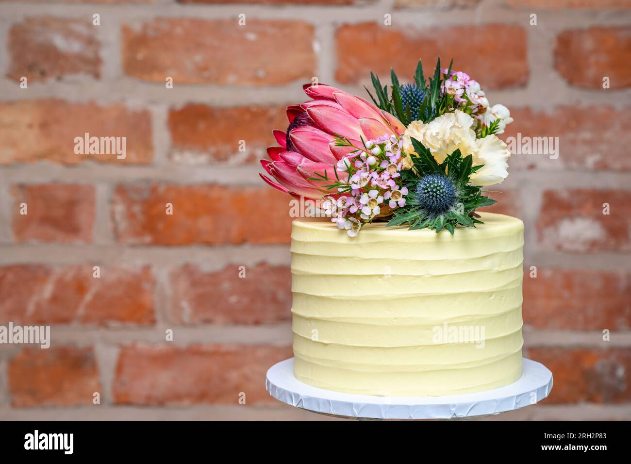 Wedding cake fresh flowers isolated Stock Photo