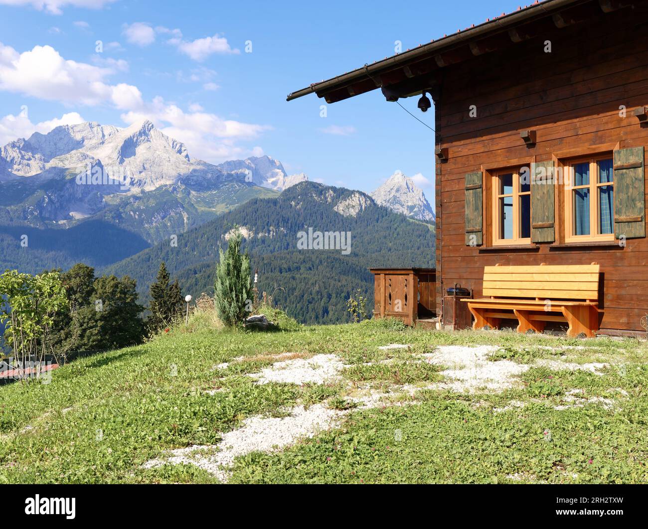 Mountain meadow with a hut and the mountains in the background. Garmisch-Partenkirchen, Germany, Mount Eckbauer Stock Photo