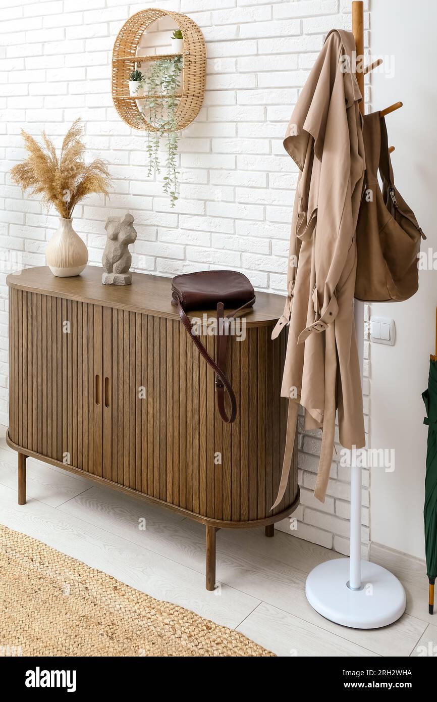Interior of light hall with shelf, drawers and rack Stock Photo - Alamy