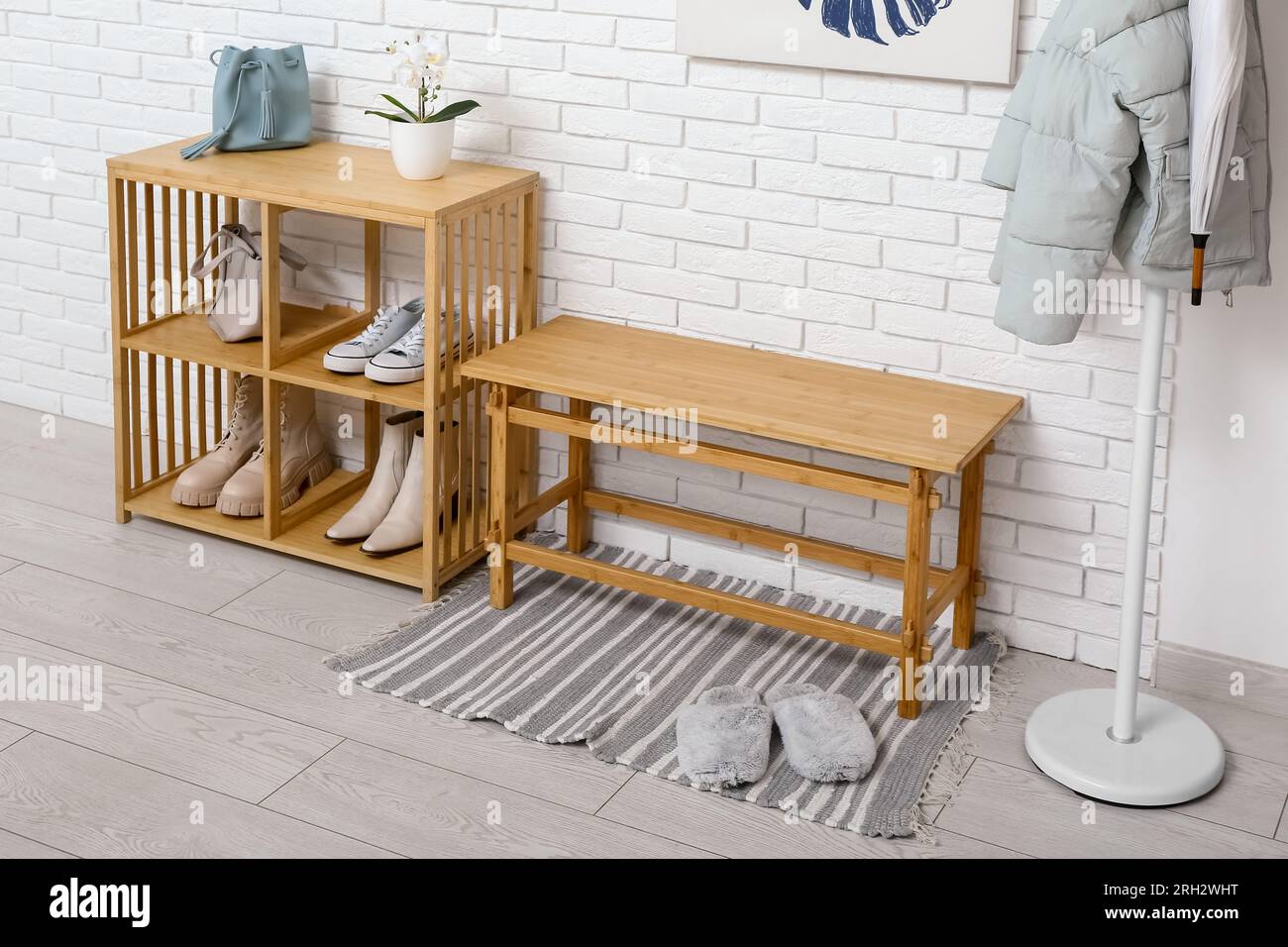Interior of light hall with rack, bench and shelving unit Stock Photo ...